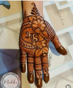 a henna is shown on the palm of someone's hand with intricate designs