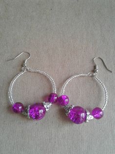 Smaller hoop earrings that I made using clear seed beads and purple crackle beads. These earrings are made just like the other bigger pair that I have in my shop, which can be found here.. https://www.etsy.com/listing/520396293/purple-and-clear-beaded-hoop-earrings?ref=shop_home_active_11 2022 Earrings, Diy Earrings Dangle, Earrings Handmade Beaded, Handmade Bead Jewellery, Diy Earrings Easy, Beaded Earrings Diy, Beaded Earring, Earrings Purple, Purple Earrings