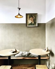 two wooden tables sitting next to each other in a room