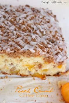 a piece of cake sitting on top of a white plate next to an orange slice