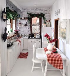 the kitchen is decorated for christmas with red and white decor