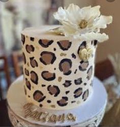 a leopard print cake with white flowers on top