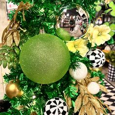 a christmas tree decorated with ornaments and greenery