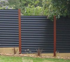 a black fence with wooden slats on it