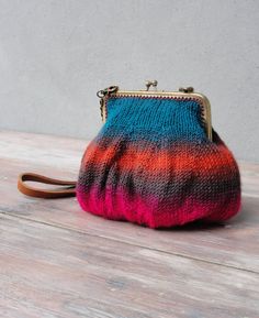 a small purse sitting on top of a wooden table