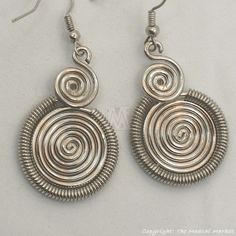 pair of earrings with spiral design on white background