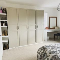 a bedroom with a bed, desk and closets