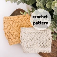 three crochet hats sitting on top of each other next to a potted plant