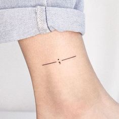 a woman's foot with a small tattoo on the left side of her ankle