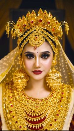 a woman wearing gold jewelry and a veil