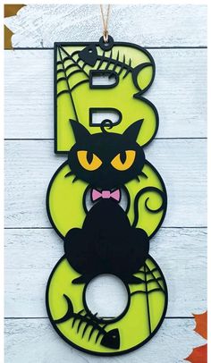 the number three with a cat on it is hanging from a wooden sign that says 3