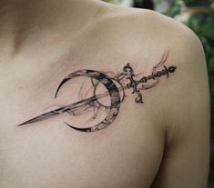 a man with a tattoo on his chest holding a knife in the shape of a crescent