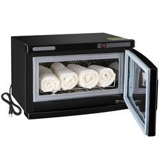 a black microwave oven with four rolled up food items in it's front door