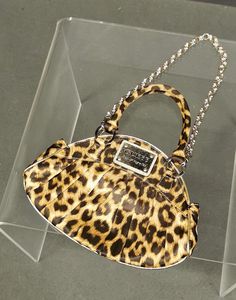 Elevate your accessory game with this striking Vintage Guess Los Angeles handbag. Crafted with a bold leopard print design, this bag is a statement piece perfect for any fashion-forward wardrobe. This bag effortlessly combines vintage charm with modern glamour, making it a versatile accessory for both day and night. Whether you're heading to a special event or simply want to add a touch of sophistication to your everyday look, this Guess handbag is the perfect choice. Why You'll Love It: - Unique and eye-catching design - Durable and stylish construction - Perfect for various occasions Don't miss out on adding this timeless piece to your collection. Grab it now and make a bold fashion statement! --- Feel free to adjust the dimensions and any other details as needed. Excellent vintage condi Leopard Print Top Handle Bag For Evening, Leopard Print Top Handle Evening Bag, Elegant Evening Shoulder Bag In Leopard Print, Chic Leopard Print Party Bag, Chic Leopard Print Party Bags, Elegant Leopard Print Party Bag, Leopard Print Handbags, Guess Handbags, Day And Night