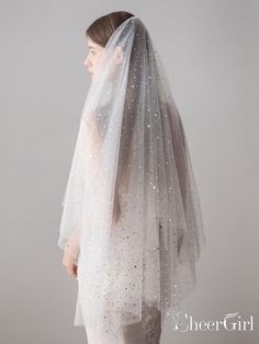 a woman wearing a veil with stars on it