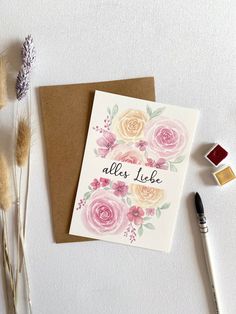 a card that says, alles lief on it next to some dried flowers