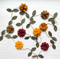 the flowers are made out of paper and tied together with twine on white wood