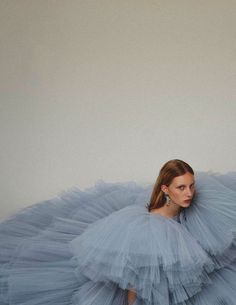 a woman in a blue dress standing on the ground