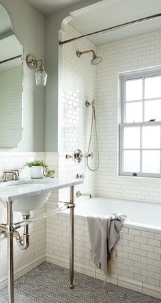 a bathroom with a sink, mirror and bathtub