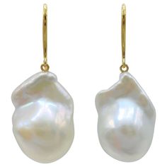 Indulge in the alluring grace of our Iridescent White Baroque Pearl Drop Earrings with 18K Yellow Gold French Hooks, crafted to captivate and inspire. These remarkable earrings feature stunning Freshwater Cultured Baroque Pearls, boasting a brilliant white hue that exudes timeless elegance. Each earring showcases a single Iridescent White Baroque Pearl with a combined weight of 37.50 carats. The pearls mesmerize with their distinct shapes and mesmerizing luster, measuring approximately 20.33mm x Luxury Teardrop Earrings With High Luster, Elegant Drop Earrings With High Luster, Luxury Drop Jewelry With High Luster, Elegant High Luster Drop Earrings, Luxury High Luster Drop Jewelry, Luxury Briolette Pearl Earrings, Luxury Yellow Gold Drop Pearl Earrings, Formal Briolette Earrings With High Luster, High Luster Briolette Earrings For Formal Occasions