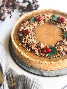 a pie with cranberries and nuts on top