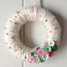 a yarn wreath with buttons attached to it