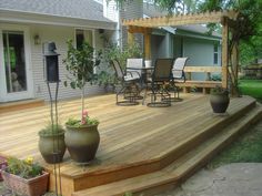 a wooden deck with potted plants on it