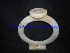 two white marble rings on top of each other in the shape of a ring with an animal's head