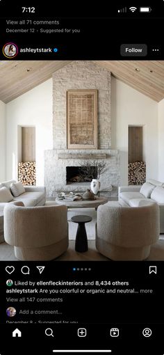 a living room filled with furniture and a fire place in the middle of an open floor plan