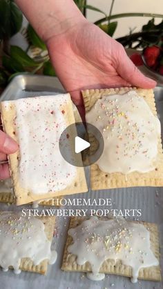 someone is making homemade strawberry pop tarts with icing and sprinkles