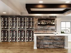 a wine cellar with two bar stools in front of it and several bottles on the wall