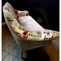 a chair that is sitting on top of a tile floor in front of a black wall