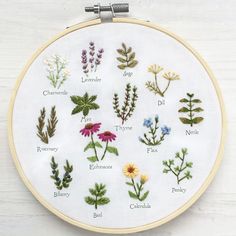 a cross stitch pattern with different types of flowers and herbs in the hoop on a white surface