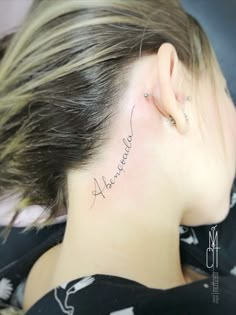 a woman's behind the ear tattoo saying, always