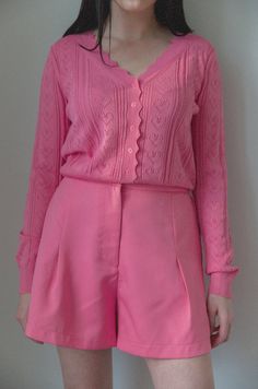 This hot pink knit cardigan features a charming pointelle heart design and button closure, adding a touch of whimsy to any outfit. Its cropped fit and scalloped hem give it a unique look, while the V-neckline and long sleeves provide comfort and versatility. Perfect for layering or adding a pop of color to any wardrobe. hot pink pointelle hearts cropped fit scalloped hem button front v-neckline long sleeves model is wearing a small Fitted Feminine Cardigan, Fitted Pink Feminine Cardigan, Fitted Feminine Pink Cardigan, Pink Fitted Pointelle Knit Sweater, Fitted Pink Pointelle Knit Sweater, Pink Pointelle Knit Cardigan, Feminine Pink Pointelle Knit Sweater, Long Black Cardigan Sweater, Curvy Date Night Outfit