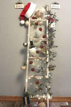 a ladder decorated with christmas ornaments and lights