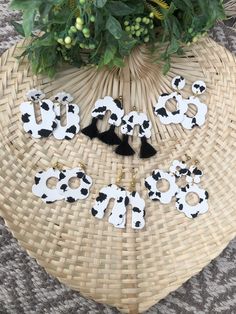 the letters are made out of black and white cow's heads on a wicker basket