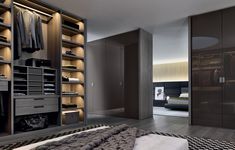 a large walk in closet next to a bed