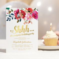 a cupcake on a plate next to a card that says sah it's surprise birthday party