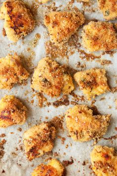 some fried food is laying on a piece of parchment paper