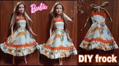 the doll is wearing a dress with an orange and white flower pattern on it's skirt