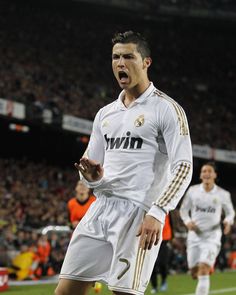 the soccer player has his mouth open as he stands on the field in front of an audience