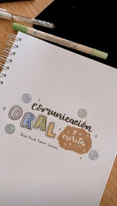 a notepad with the words communication oral written in cursive writing on it