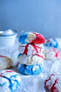 red, white and blue cookies are stacked on top of each other with icing