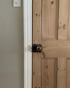 the door is made of wood and has a metal latch on it's side