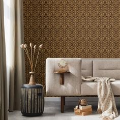 a living room scene with focus on the couch and wall papered walls in the background