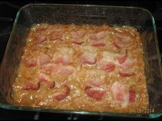 a casserole dish with ham and cheese in it on top of the stove