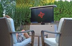 two chairs sitting in front of a flat screen tv