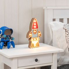 Give your little astronaut their own outer space. This wooden rocket LED table lamp will sit ready for lift off on any surface, but it’s also got a hole in the back if you want to hang it up and show it off mid-flight.

Dimensions: Height 24cm, Depth 2.8cm, Diameter 13.5cm.
Requires 3 x AA batteries.
Slide switch.
Surround with some star string lights to add a galaxy for the rocket to explore. Rocket Lamp, Star String Lights, Pets For Sale