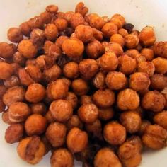 a pile of chickpeas sitting on top of a white plate